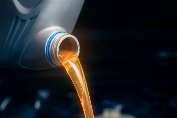 istock Pour engine oil from the lubricant bottle. Engine background, oil change shop engine service industry 2147392291