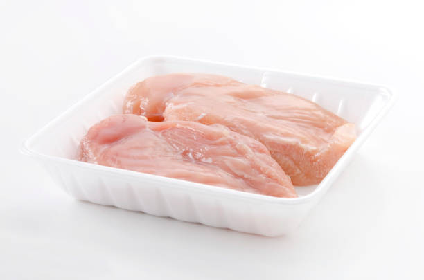 istock Raw Chicken breast on a foam tray on a white background 2147402607