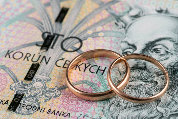 istock Wedding rings and a 100 Czech crown banknote 2147405795