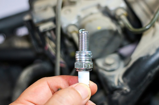 Pictures of spark plug with concept maintenance and repair motorcycles.