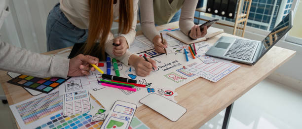 istock Brainstorm team of creative web graphic designer planning, Group of mobile phone app developer team meeting for share ideas about screen prototype layout for smartphone. startup planning ui and ux 2147411275