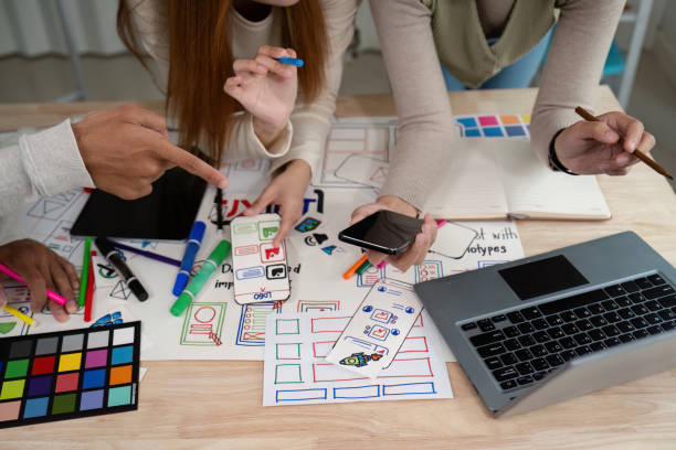 istock Brainstorm team of creative web graphic designer planning, Group of mobile phone app developer team meeting for share ideas about screen prototype layout for smartphone. startup planning ui and ux 2147411933