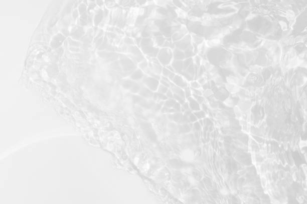 istock White water with ripples on the surface. Defocus blurred transparent white colored clear calm water surface texture with splashes and bubbles. Water waves with shining pattern texture background. 2147419570
