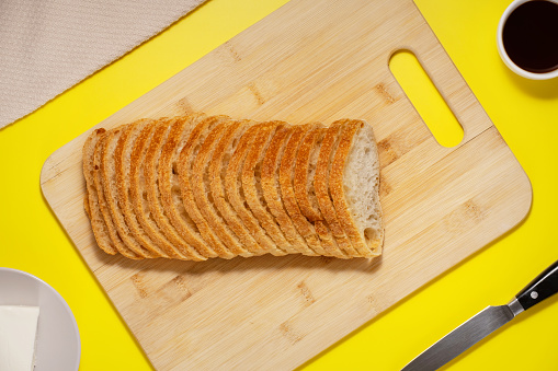 Ciabatta bread sliced on a board, top view.