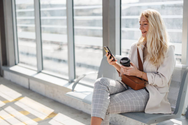 istock Businesswoman Enjoying Coffee Break While Using Smartphone 2147487571
