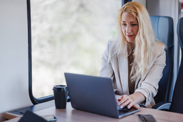 istock Businesswoman Working on Laptop While Commuting on Train 2147487589