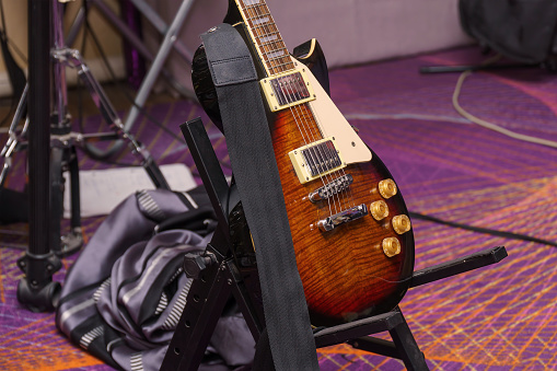 Electric guitar on a stand in the rehearsal room