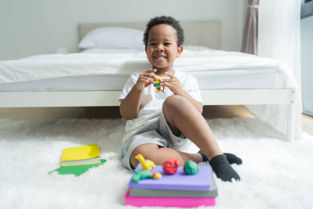 istock Cute little boy making things from plasticine on the ground Follow your imagination with a smiling. 2147488058