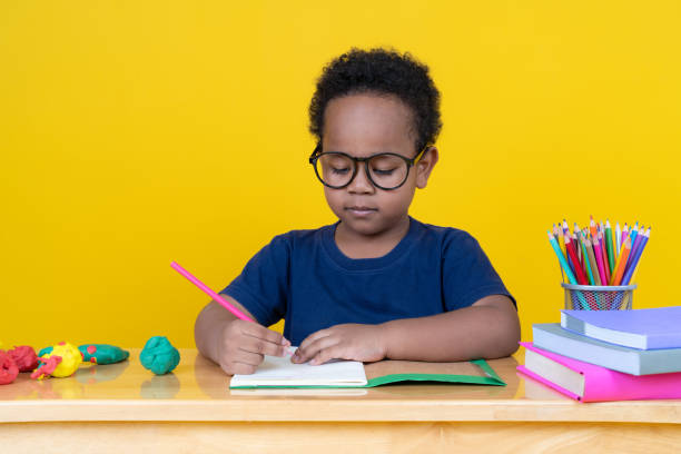 istock Little boy with imagination Sitting at the table drawing with colored pencils. 2147488092