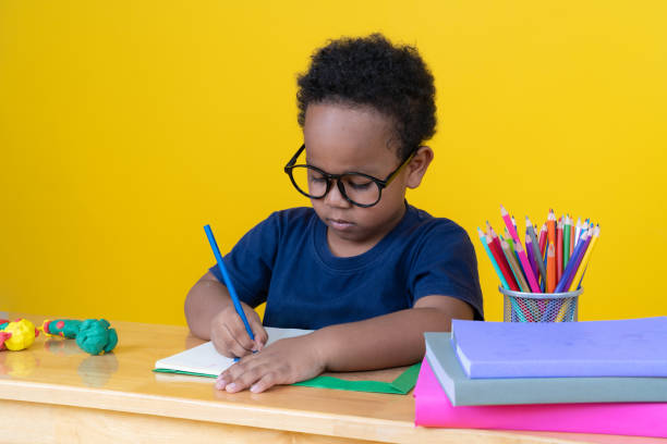 istock Little boy with imagination Sitting at the table drawing with colored pencils. 2147488095