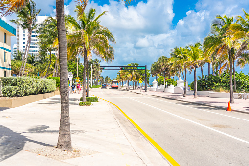 Seafront beach promenade with palm trees on sunny day in Fort Lauderdale