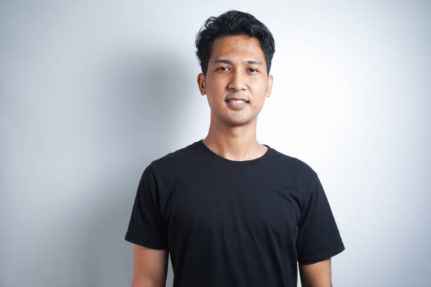 istock man wearing black t-shirt looking at camera and smiling confidently 2147488895