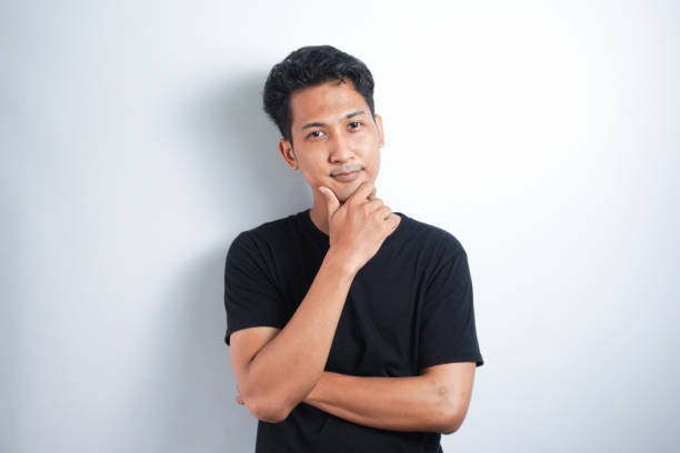 istock Photo of thoughtful man isolated over white background wall. Looking aside. 2147489027