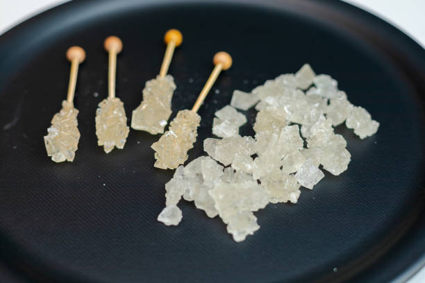 White and brown chrystal sugar on slate copy space background