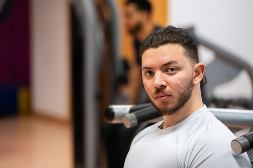 Intense young man at gym preparing for a workout.