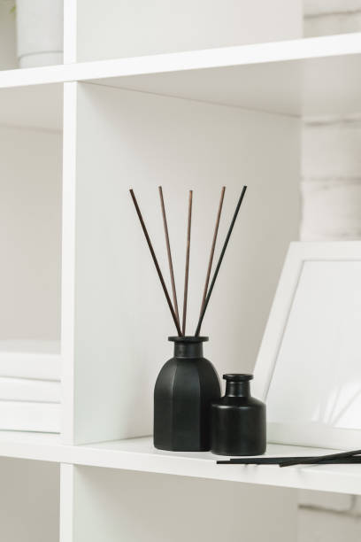 istock Elegant Black Reed Diffuser on White Shelf in Minimalist Home Decor Setting 2147495503
