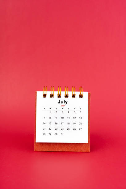 istock July 2024 white mini desk calendar on red background. 2147496693