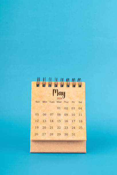 istock May 2024 white desk calendar on blue background. 2147496694