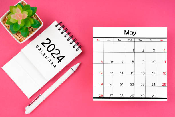 istock White calendar for May 2024 and pen on pink color background. 2147496711