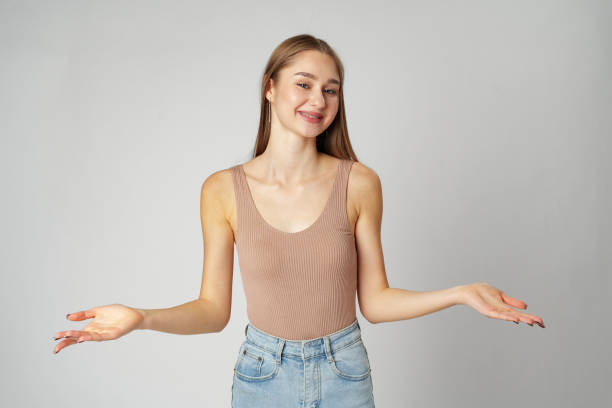 istock Clueless Young Woman Holding Out Her Hands Gesturing She Doesn't Know 2147498992