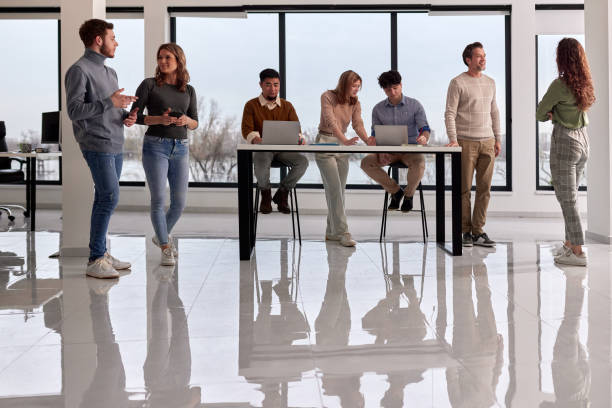 istock Multi-tasking business colleagues working in a casual office. 2147499382