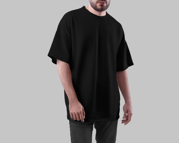 istock Oversized black t-shirt template on bearded man in jeans, front view, isolated on background. 2147500175