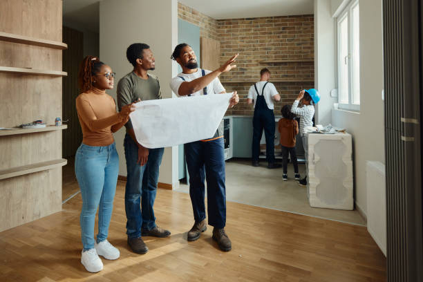 istock Black parents and manual worker making plans in the apartment. 2147500376