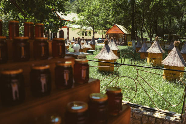 apiary in Abkhazia. blured foreground of stack of jars with honey.