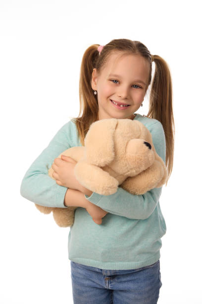 Adorable girl with teddy bear on white background