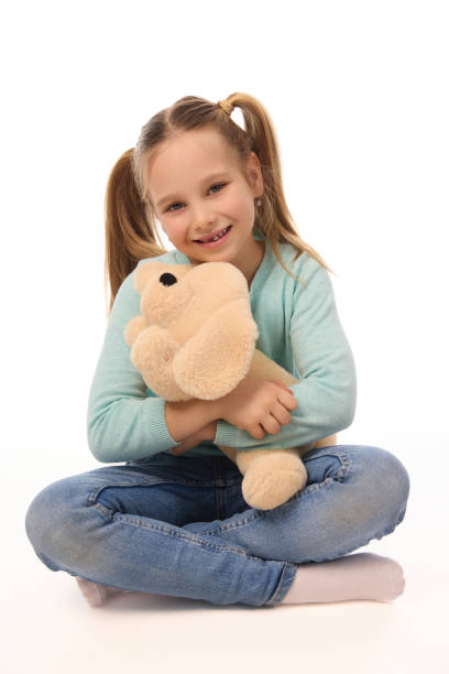 istock Adorable girl with teddy bear on white background 2147500730