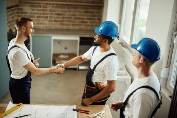 istock Happy manual workers came to an agreement in moving apartment. 2147501459
