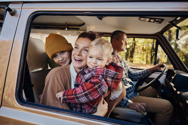 istock Happy family enjoying while traveling by a van. 2147502892