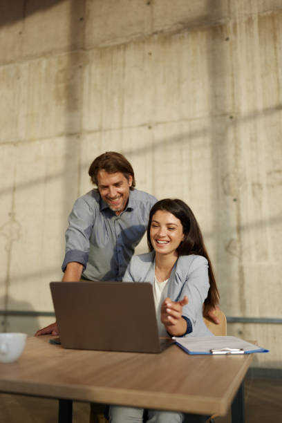istock Happy business colleagues working on a computer in the office. 2147503698