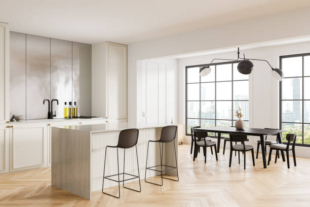 istock Stylish home kitchen interior with cabinet and dining table, panoramic window 2147503773
