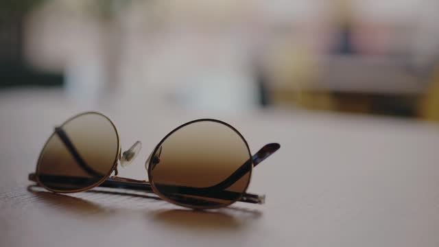 Closeup on trendy sunglasses on table in cafe
