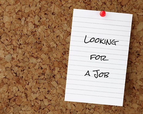 Note pinned on cork board with text written Looking For A Job - concept of people who needs work or looking for job, unemployment rising in down economy