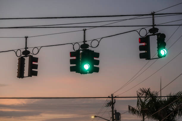 istock Traffic light with green light against the evening sky with sunset. 2147504843