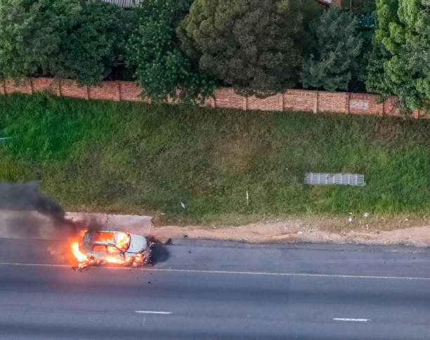 Central California, USA - February 21, 2023: Car on fire on the side of the I-5 freeway in Central California near Stockton.