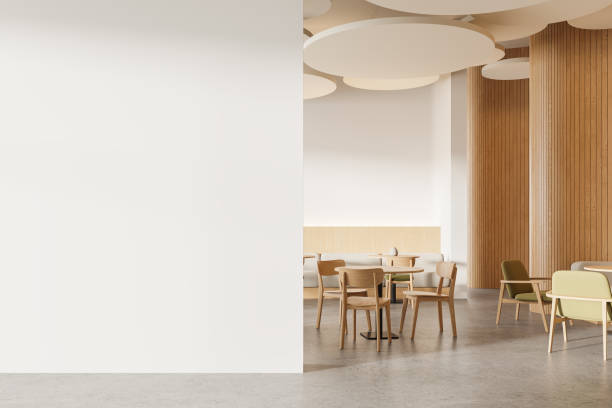 istock White and wooden cafe interior with sofas and blank wall 2147508645