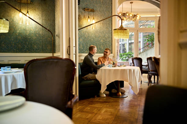 istock Men enjoying a lunch date at secluded table for two 2147509973