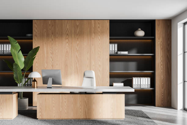 istock Stylish business interior with work table, pc computer and shelf near window 2147510293