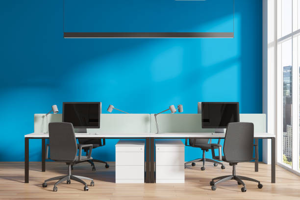 istock Office coworking interior with desk and pc monitors, panoramic window 2147510644