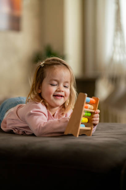 istock Little girl playing whit abacus at home 2147510689