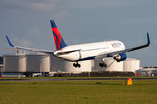 Amsterdam, Netherlands - August 15, 2014: Delta Airlines passenger plane at airport. Schedule flight travel. Aviation and aircraft. Air transport. Global international transportation. Fly and flying.