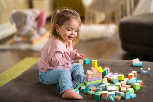 istock Girl playing whit toy blocks at home 2147511500