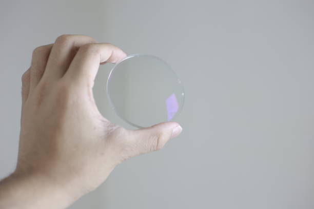istock Glasses lenses, eyeglasses lenses in hand 2147512029