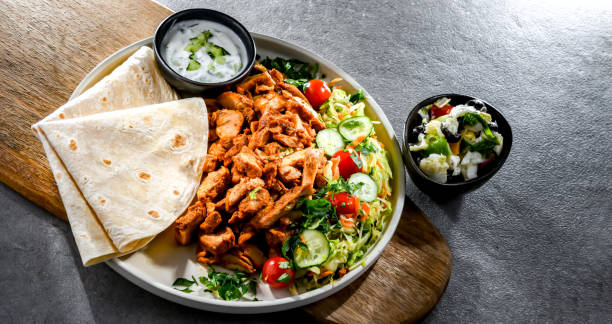 istock Kebab served with pita bread, vegetable salad and tzatziki 2147512122