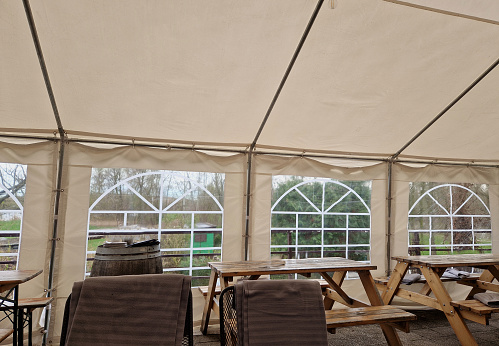 Sheets made of non-flammable material
PVC tarpaulin for trucks rear entrance equipped with zip windows made of transparent plastic Steel frame of the tent made of galvanized pipes, table, pub