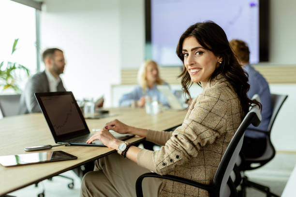 istock Radiant professional woman excels during a dynamic office meeting in bright workspace 2147512328