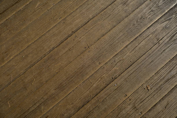 While the rustic wooden grain pattern is beautiful, the grunge and scratches indicate it is time for a new floor. The background offers lots of texture and patterns.
